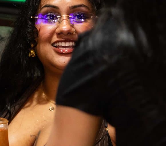 A smiling guest at a table in Pub 36