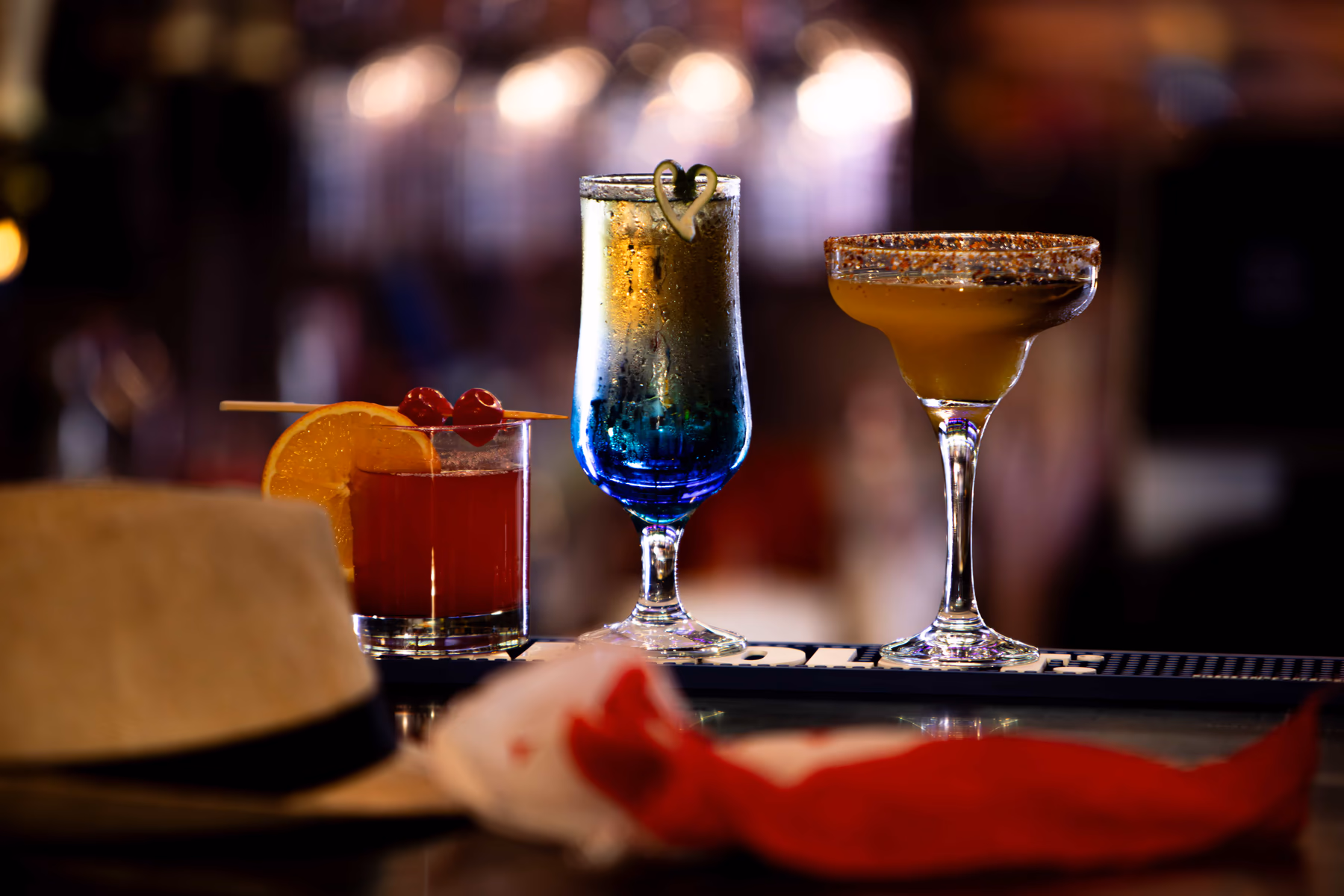 Three colourful cocktails lined up across the Pub 36 bar